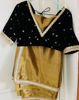 Picture of Golden semi tissue saree with black velvet blouse