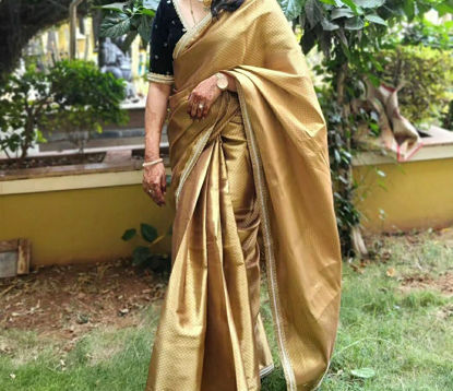 Picture of Golden semi tissue saree with black velvet blouse