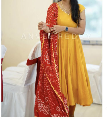Picture of Mustard yellow anarkali with red modal silk bhandhini duppata.