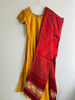 Picture of Mustard yellow anarkali with red modal silk bhandhini duppata.