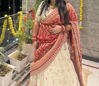 Picture of Ivory lehanga with red bhandej duppata