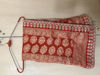 Picture of Ivory lehanga with red bhandej duppata